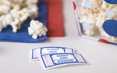 Popcorn bowl with movie tickets..