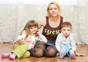 mother with son and daughter on a floor