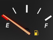 A closeup of a car fuel gauge showing empty