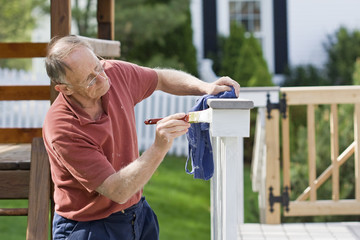 Man painting fence