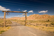 A gate and a fence in desert, wild west