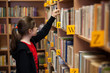 © Jacek Chabraszewski - Young girl in library looking for books