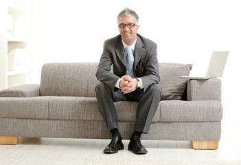 Businessman sitting on couch