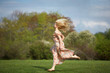 © Veronika Seppanen - Young woman jumping  on meadow