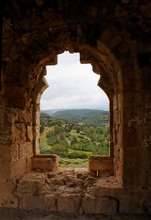 Green Hills Seen Through Window Of Ruined Ancient Castle