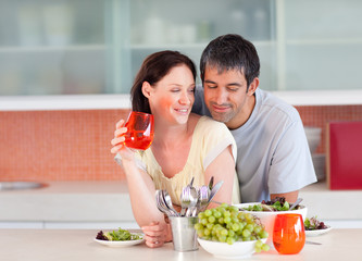 Couple eating and drinking in the kitchen