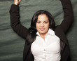 Woman with her jacket unbuttoned and her arms above her head