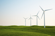 Wind Turbines On Green Grass Field