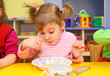 © Pavel Losevsky - Little girl eats in kindergarten
