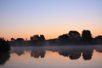 Wall Mural - Fog above a lake