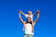 © WavebreakMediaMicro - Father giving his son a piggyback ride