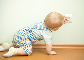 child near the socket