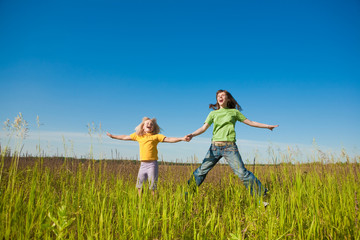 Wall Mural - Happy mother and daughter on field