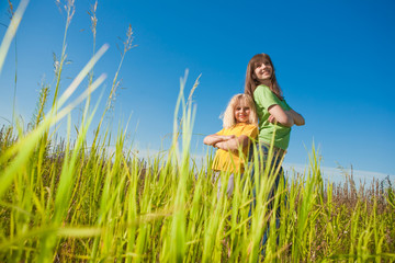 Wall Mural - Happy mother and daughter on field