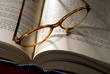 Close up of reading glasses and book