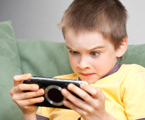 Boy playing game console