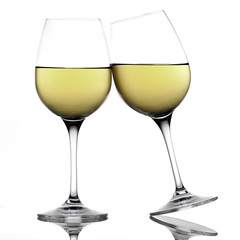 White wine glasses making a toast