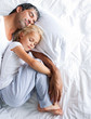 © WavebreakMediaMicro - Father and daughter sleeping on bed