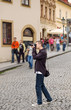 Photographer taking pictures outdoor and tourists passing by