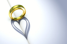 Wedding Ring And Heart Shaped Shadow Over A Blank Book