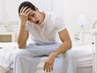 © AVAVA - Attractive Man Sitting on His Bed and Yawning