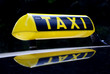 yellow neon taxi sign mirroring in the car roof