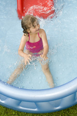 Wall Mural - Little girl playing in water