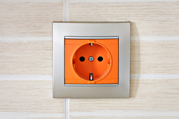 closeup of modern orange electric power socket