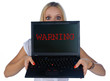 © bertys30 - woman with warning sign on laptop