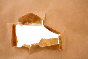 Hole ripped in brown paper