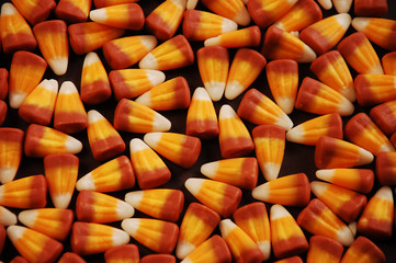 Wall Mural - Candy corn on black background