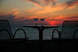 Fototapeta  - Table with goblets on background of the sundown