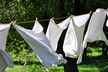 White Clean Laundry Drying On The Clothesline