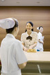 © Paylessimages - 病院の受付女性と看護師