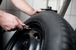 © baranq - Mechanic filling air into a car tyre.