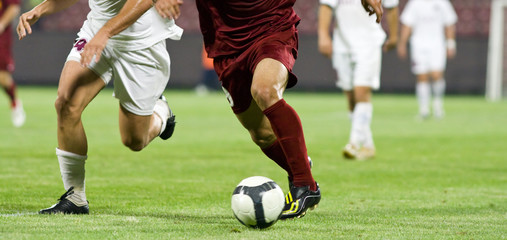 Wall Mural - Soccer players running after the ball