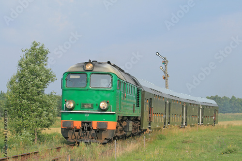 Fototapeta na wymiar Passenger train passing through polish countryside