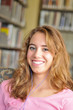 © Frank Fennema - Pretty Female Student Listens to Music in the Library