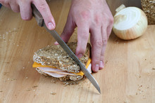 Hands Cutting Sandwich