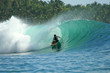 Surfer in barrel on green wave, Mentawai Islands, Indonesia
