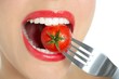 Eating a red tomato macro of woman mouth