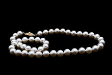 Pearls Necklace On Black Background