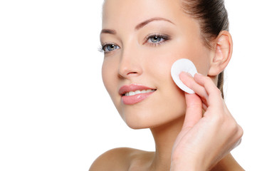 Beauty woman cleaning her health face with cotton swab