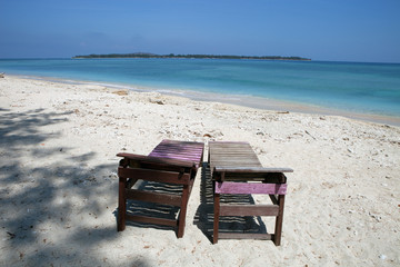 Canvas chairs on tropical beach