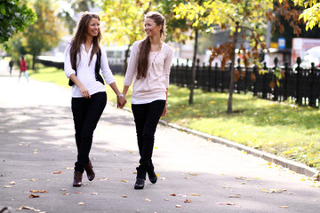  Fashionable girls twins walk in the street