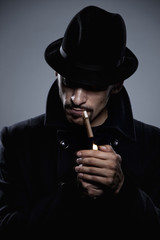 Mysterious man lighting a cigarette