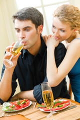 Canvas Print - Young couple celebrating with champagne at home