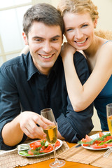 Canvas Print - Young couple celebrating with champagne at home