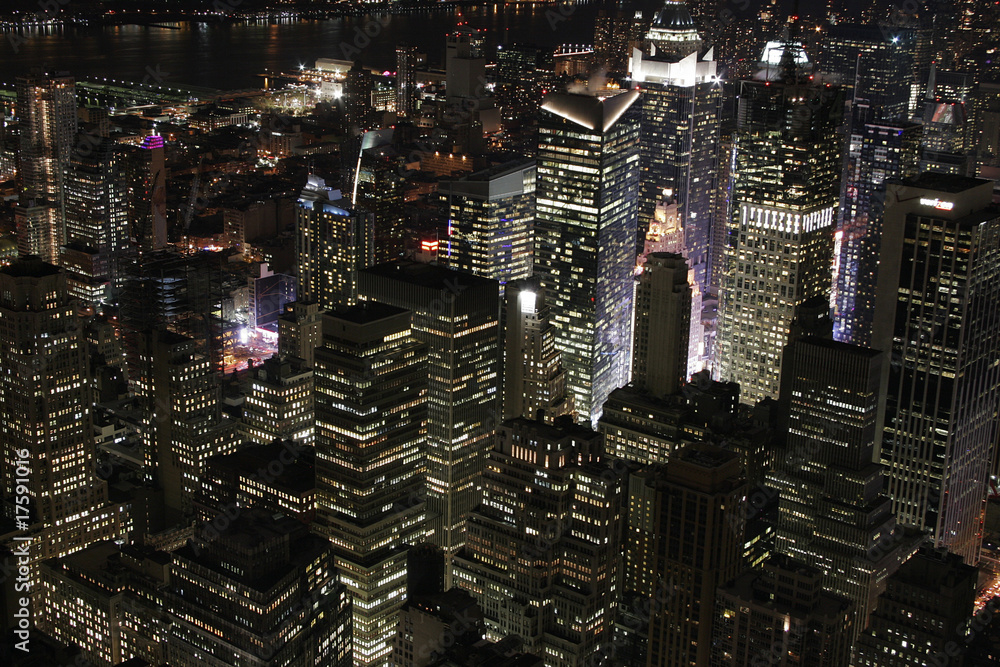Scenic skyline at night view of Midtown Manhattan from across the East ...
