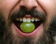 © Mazur Travel - Portrait of bearded man with grape in his mouth